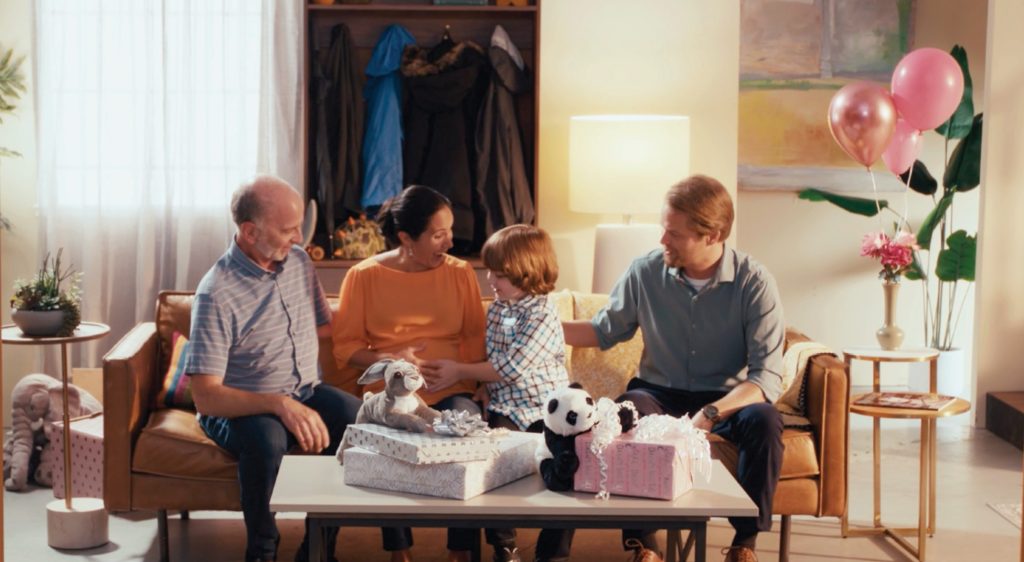 Hancock Health family sitting on couch